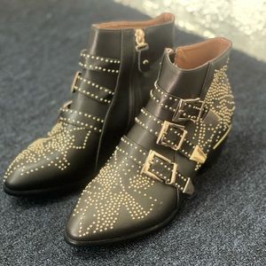 The are  black booties with gold studs  and the buckles are gold too